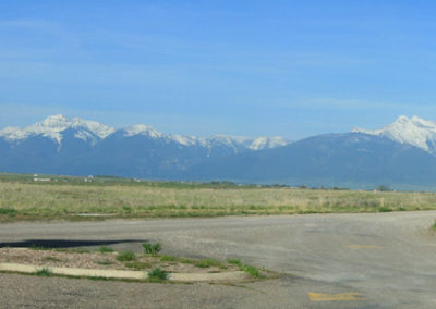 Panorama of the National Bison Range sign and the Mission Mountains.