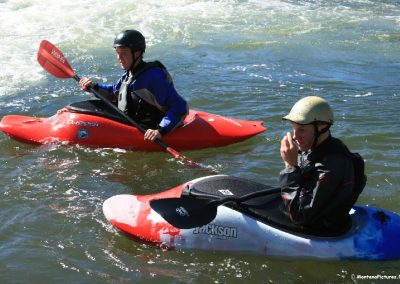 Picture of a pair Kayakers on Brennan's Wave on the Clark Fork River in Missoula, Montana.