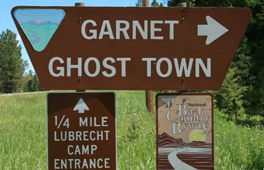 Summer picture of the Garnet, Montana sign on Highway 200. Image is part of the Garnet, Montana Picture Tour.
