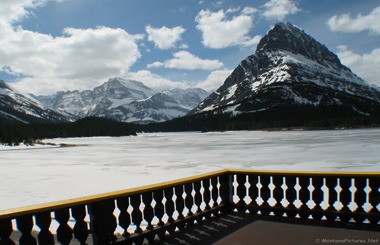 Picture from the deck of the Many Glacier Lodge of an ice covered Sherburne Lake.