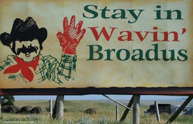 The Waving Welcome sign on Highway 212 near Broadus, Montana in SE Montana. Image is part of the Broadus, Montana Picture Tour.