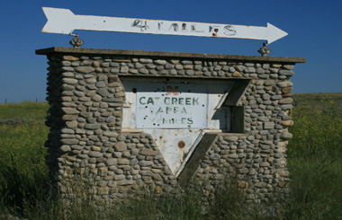 Picture of the unusual Cat Creek, Montana sign on Highway 200, twenty-two west of Winnett, Montana.