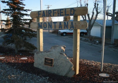 March picture of the Fairfield Montana welcome sign on Highway 89. Image is from the Freezeout Lake Picture Tour.