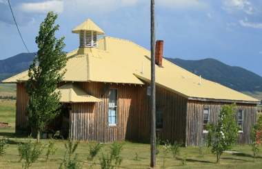 June picture the old Schoolhouse in Brooks, Montana Welcome Sign. Image is from the Brooks, Montana Picture Tour.