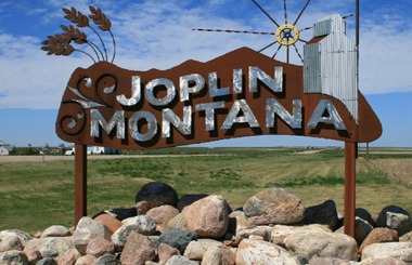 June picture of the Joplin, Montana Welcome sign on Highway 2. Image is from the Joplin, Montana Picture Tour.