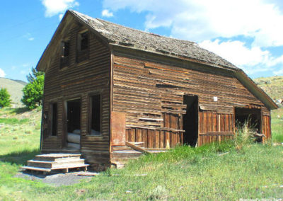 July picture of a two story wooden building in Glendale, Montana. Image is from the Dewey, Montana Picture Tour.