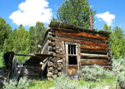 July picture of a miner’s cabin in the Pioneer Mountains. Image is from the Divide, Montana Picture Tour.