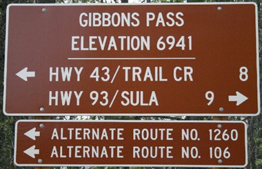 July picture of the brown elevation sign on Gibbons Pass in SW Montana. Image is from the Gibbons Pass Picture Tour.