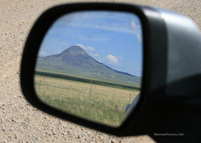 June view of Gold Butte (6512 feet) in the Sweet Grass Hills from the car mirror. Image is from the Sweet Grass Hills Montana Picture Tour.