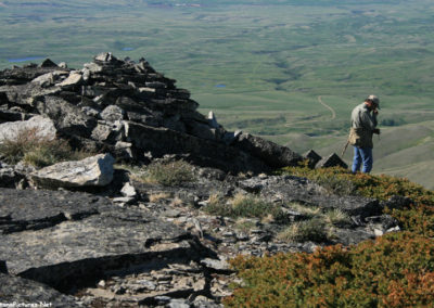 June picture of one of the ancient the rock structures and a hiker on the summit of Gold Butte (6512 feet) in the Sweet Grass Hills. Image is from the Sweet Grass Hills Montana Picture Tour.