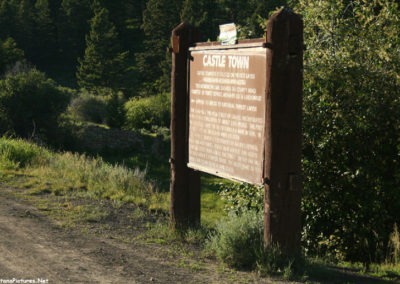 June sunset picture of the Castle Town Montana Historical Marker on Forest Service Road 211. Image is from the Castle Town Montana Picture Tour.