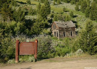June picture of the Castle Town Montana Historical Marker and cabin on Forest Service Road 211 in Central Montana. Image is from the Castle Town Montana Picture Tour.
