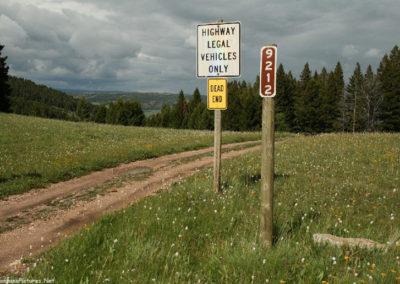 June picture of road signs along Forest Service Road 211 in the Castle Mountains. Image is from the Castle Town Montana Picture Tour.
