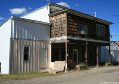 June picture of a covered porch in Martinsdale, Montana. Image is from the Martinsdale and Lennep Town Montana Picture Tour.