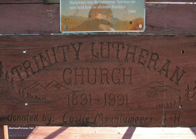 June picture of the Trinity Lutheran Church sign on the church in Lennep, Montana. Image is from the Martinsdale and Lennep Town Montana Picture Tour.