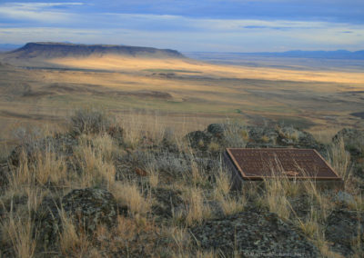 October picture of the Nature Conservancy Plaque on the summit of Crown Butte with Square Butte in the background. Image is from the Crown Butte Preserve & Simms Montana Picture Tour.