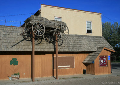 July picture of a wooden wagon display in Whitehall, Montana. Image is from the Whitehall Montana Picture Tour.