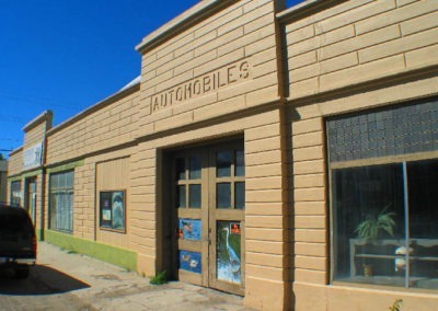 August picture of a 1920’s automobile building in Whitehall, Montana. Image is from the Whitehall Montana Picture Tour.