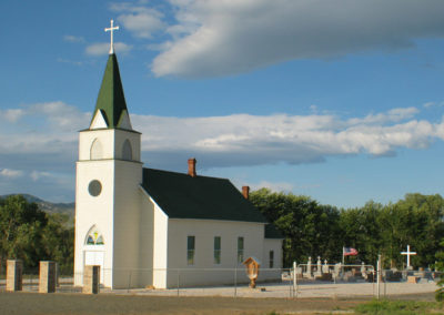 June picture of the St John Evangelist Catholic Church of the North Boulder Valley on Highway 69. Image is from the Boulder Montana Picture Tour.