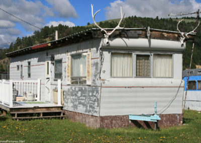 June 2018 picture of a mobile home and antlers in Checkerboard, Montana. Image is from the Checkerboard Montana Picture Tour.