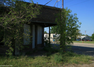 A June picture of an old abandoned corner shop in Westby, Montana. Image is from the Westby Montana Picture Tour.