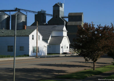 A June picture of the Assembly of God Church and Grain Elevators in Westby, Montana. Image is from the Westby Montana Picture Tour.