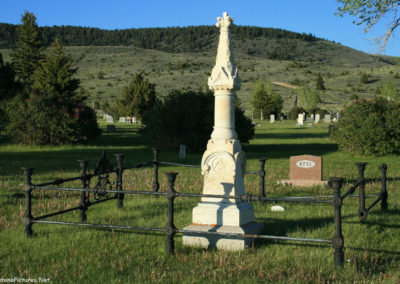June picture of tall spire shaped grave marker in the Virginia City, Montana Cemetery. Image is from the Virginia City, Montana Picture Tour.