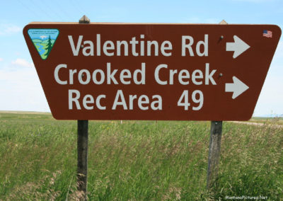 June picture of the Valentine Road Sign on Highway 191 in the Charles M Russell National Wildlife Refuge. Image is from the James Kipp Recreation Area Picture Tour.