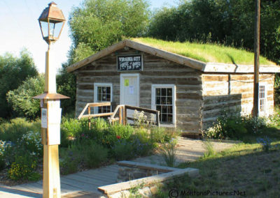 June picture of a log cabin containing the Forge Works in Virginia City, Montana. Image is from the Virginia City, Montana Picture Tour.
