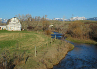 April picture of a Barn and Elk Creek from the Stearns Road. Image is from the Augusta Montana Picture Tour.