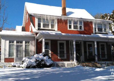 October picture of a snow covered red house in Helena Montana. Image is from the Helena Montana Winter Picture Tour.