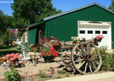 July picture of a wagon covered with flowers in Shelby Montana. Image is from the Shelby Montana Picture Tour.