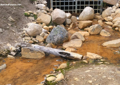 June picture of polluted waste water coming out of a mine. Image is from the Coolidge, Montana Ghost Town Picture Tour.