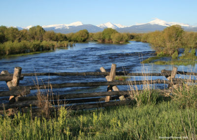 June picture of a wooden Jack Fence and the Pintlar Mountains. Image is from the Wisdom Montana Picture Tour.