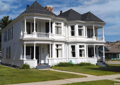 July picture of a residential home with four front porches in Anaconda Montana. Image is from the Anaconda Montana Picture Tour.