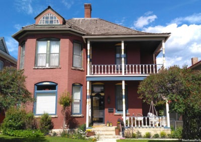 July picture of a residential home with top balcony in Anaconda Montana. Image is from the Anaconda Montana Picture Tour.