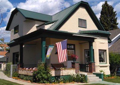 July picture of a residential home with a flag decoration in Anaconda Montana. Image is from the Anaconda Montana Picture Tour.
