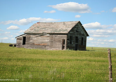 June picture of an abandoned wooden schoolhouse south of Terry Montana. Image is from the Tongue River Picture Tour.