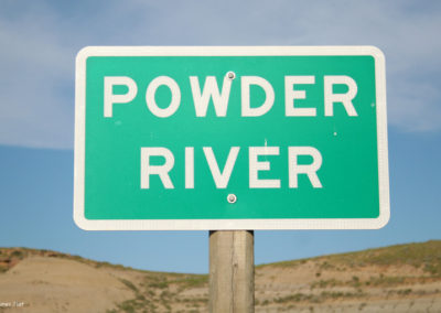 Close-up picture of the Powder River Sign on Highway 12. Image is from the Powder River Picture Tour.