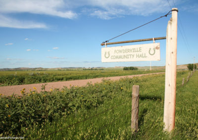 June picture of Powderville, Montana Community Center sign. Image is from the Powder River Picture Tour.