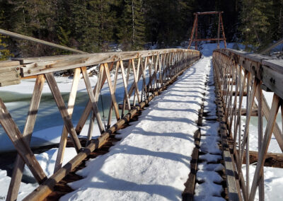 February picture of the snow covered foot bridge spanning the Lochsa River in the Clearwater National Forest. Image is from the Jerry Johnson Hot Springs Picture Tour.