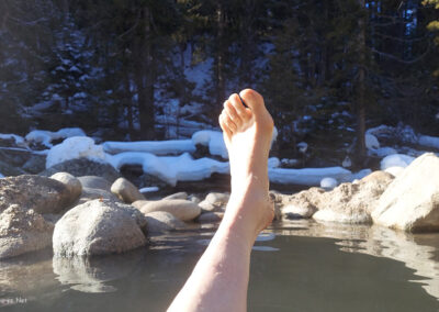 February picture of the foot of a hot springs soaker along Warm Creek below the second thermal feature at Jerry Johnson Hot Springs. Image is from the Jerry Johnson Hot Springs Picture Tour.