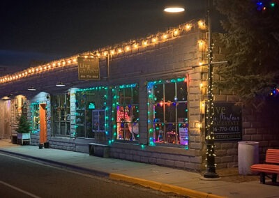 December view of the Live in Montana Real Estate Office Christmas Lights on Main Street in downtown Augusta, Montana.