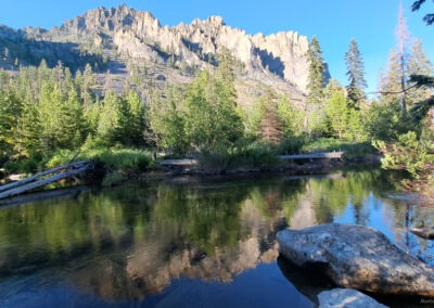 July picture of the reflection of cliffs over Blodgett Creek. Image is from the Blodgett Canyon, Montana Picture Tour.
