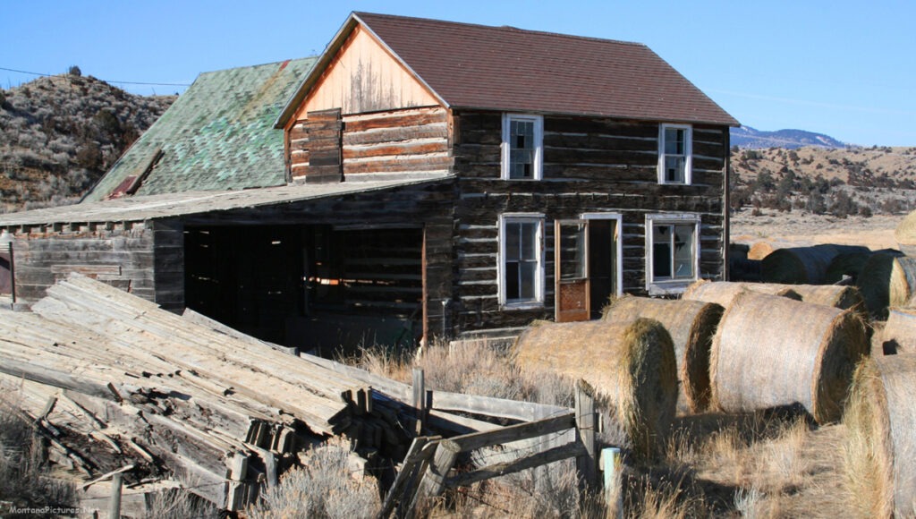 January picture of a two story log cabin home Northwest of Radersburg, Montana