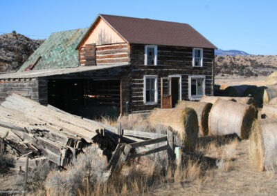 January picture of a two story log cabin home Northwest of Radersburg, Montana