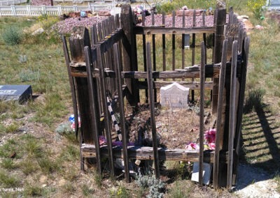July picture of Wooden picket fence surrounding a Headstone in the Radersburg Cemetery outside Radersburg, Montana
